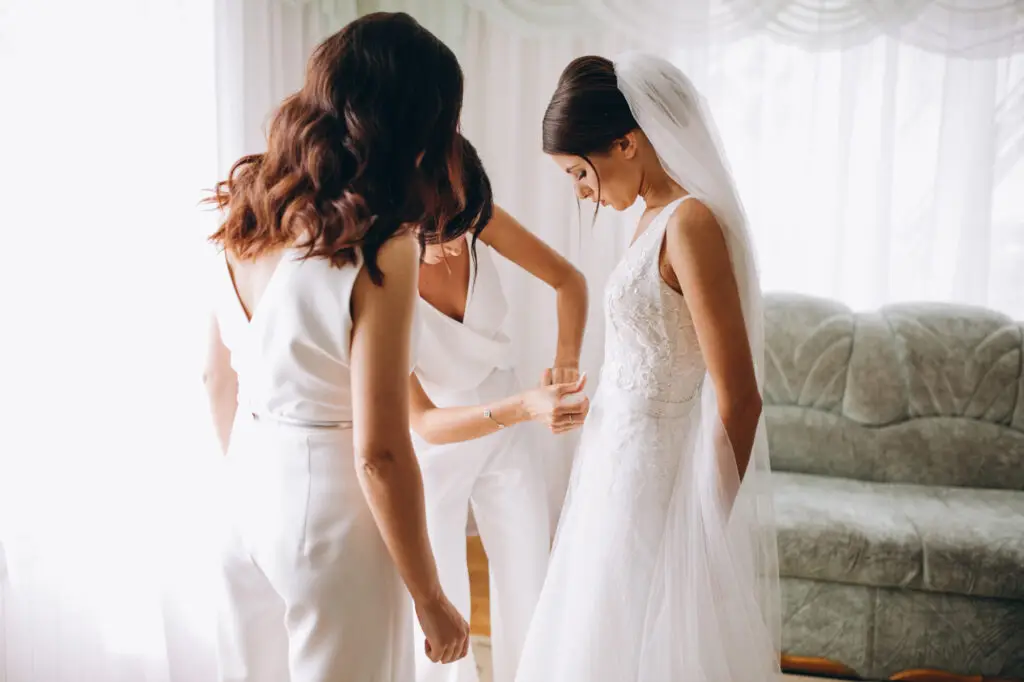 Bride getting ready with her bridesmaids on her wedding day